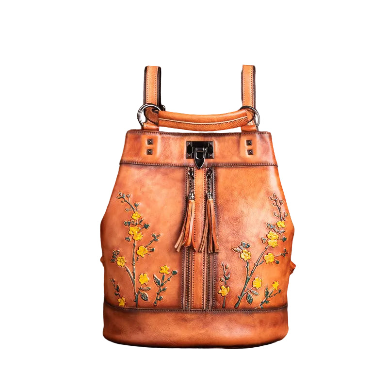 Brown leather backpack with floral embroidery on a brown background